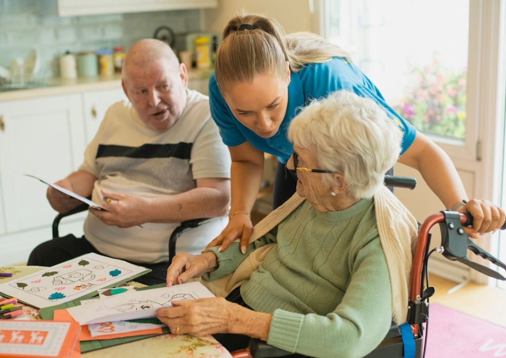 Older adults and a caregiver working on a coloring activity together