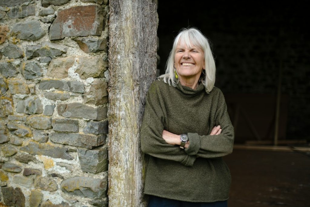 Confident older woman with gray hair smiling outdoors