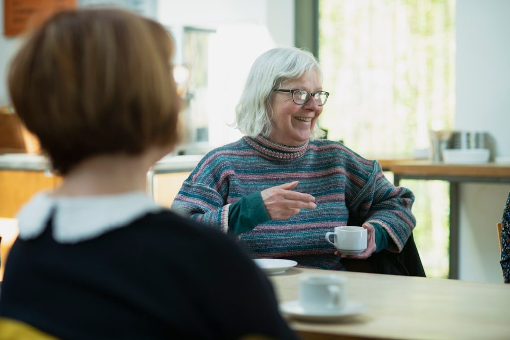 Two women sitting at a table in conversation